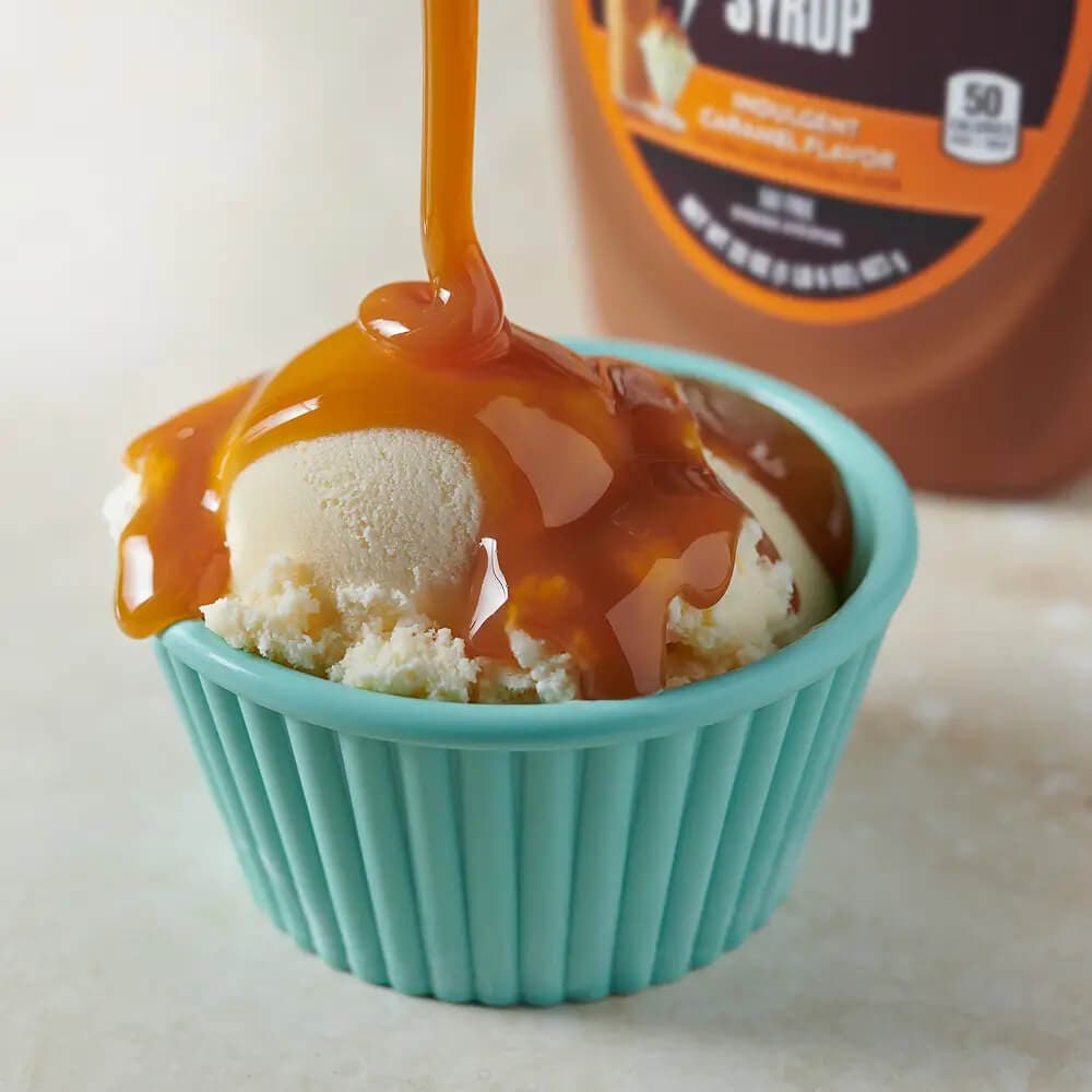 caramel syrup drizzling over vanilla ice cream
