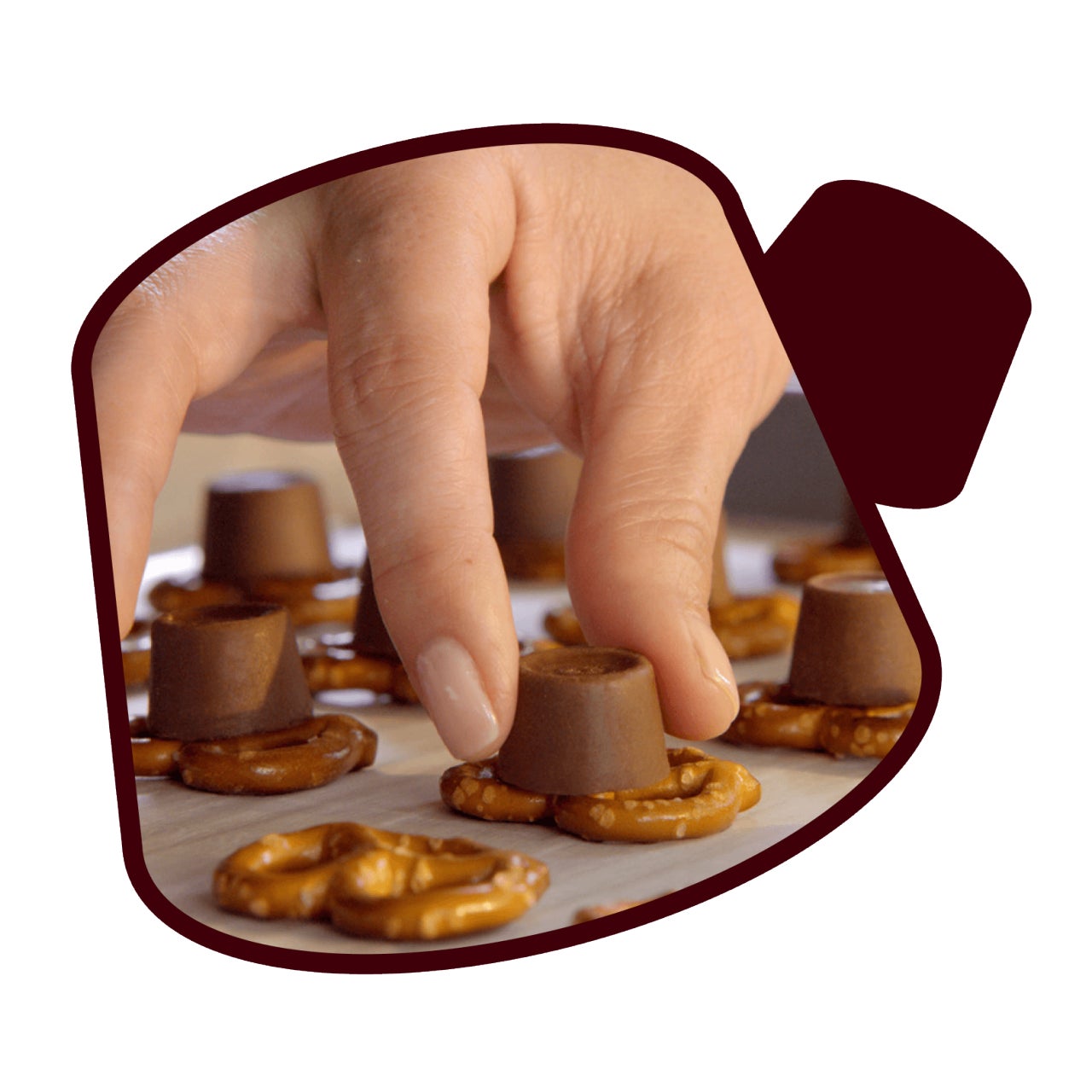 rolo candies being place on pretzels
