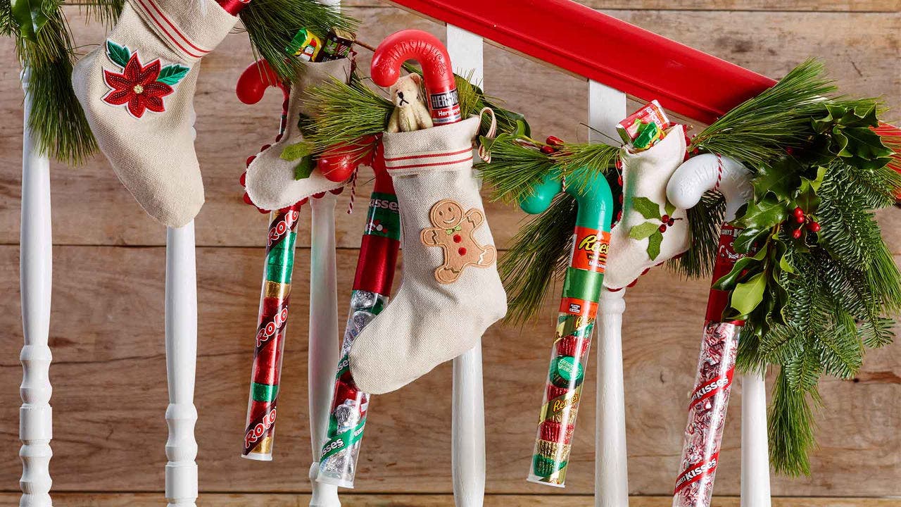 christmas stockings filled with assorted hersheys holiday candy hanging garland