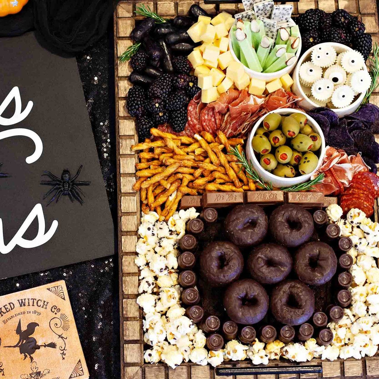 charcuterie board filled with halloween snacks and treats