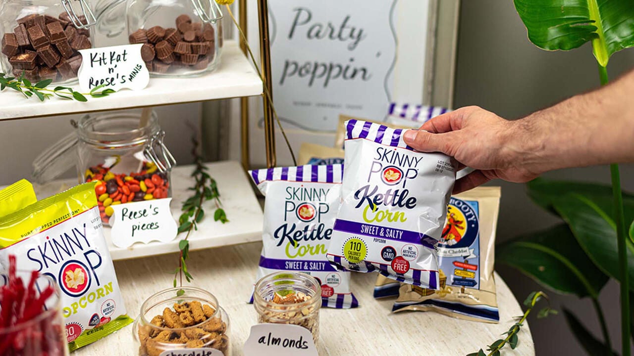 popcorn bar featuring an assortment of hersheys sweet and salty toppings